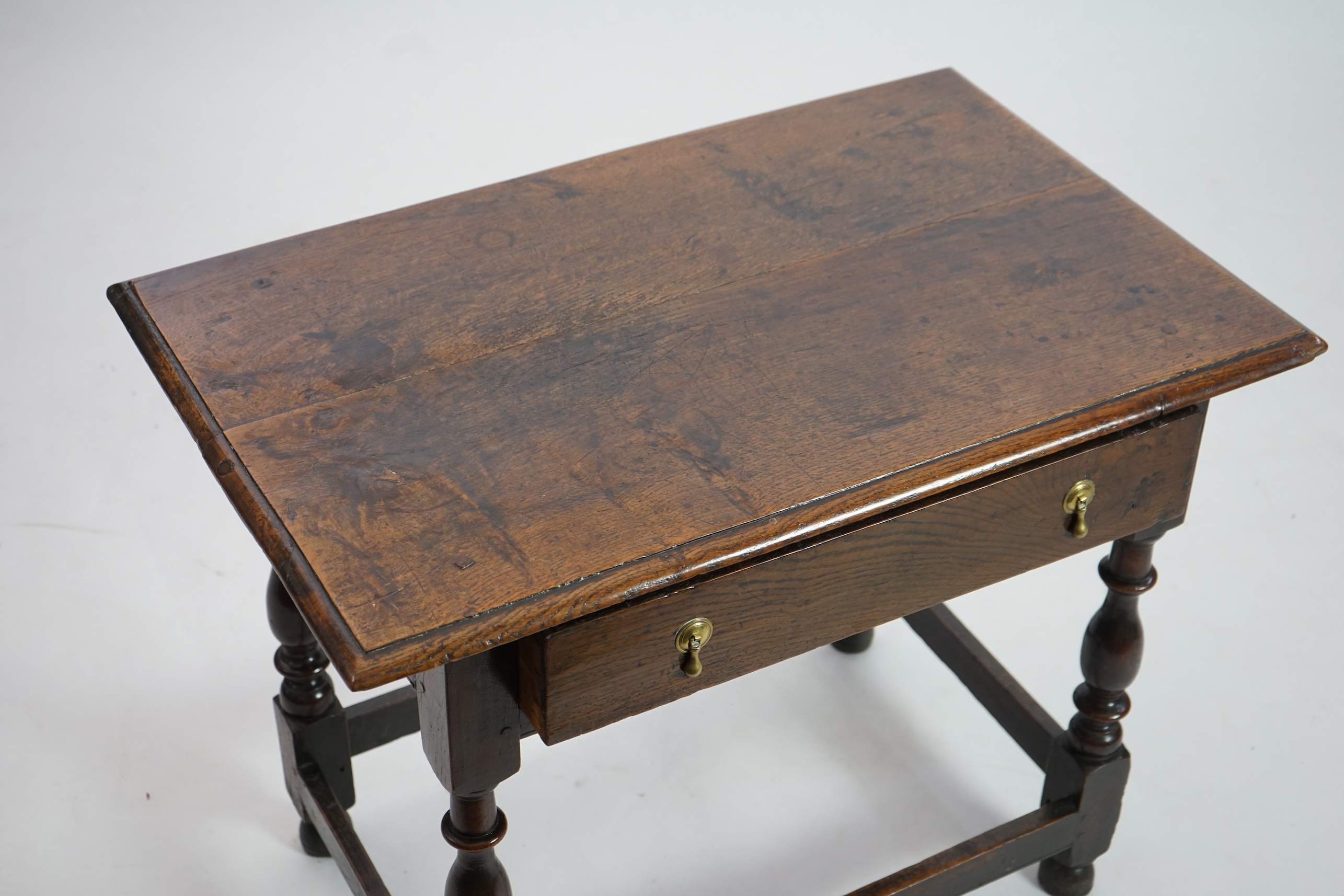 An early 18th century and later oak side table